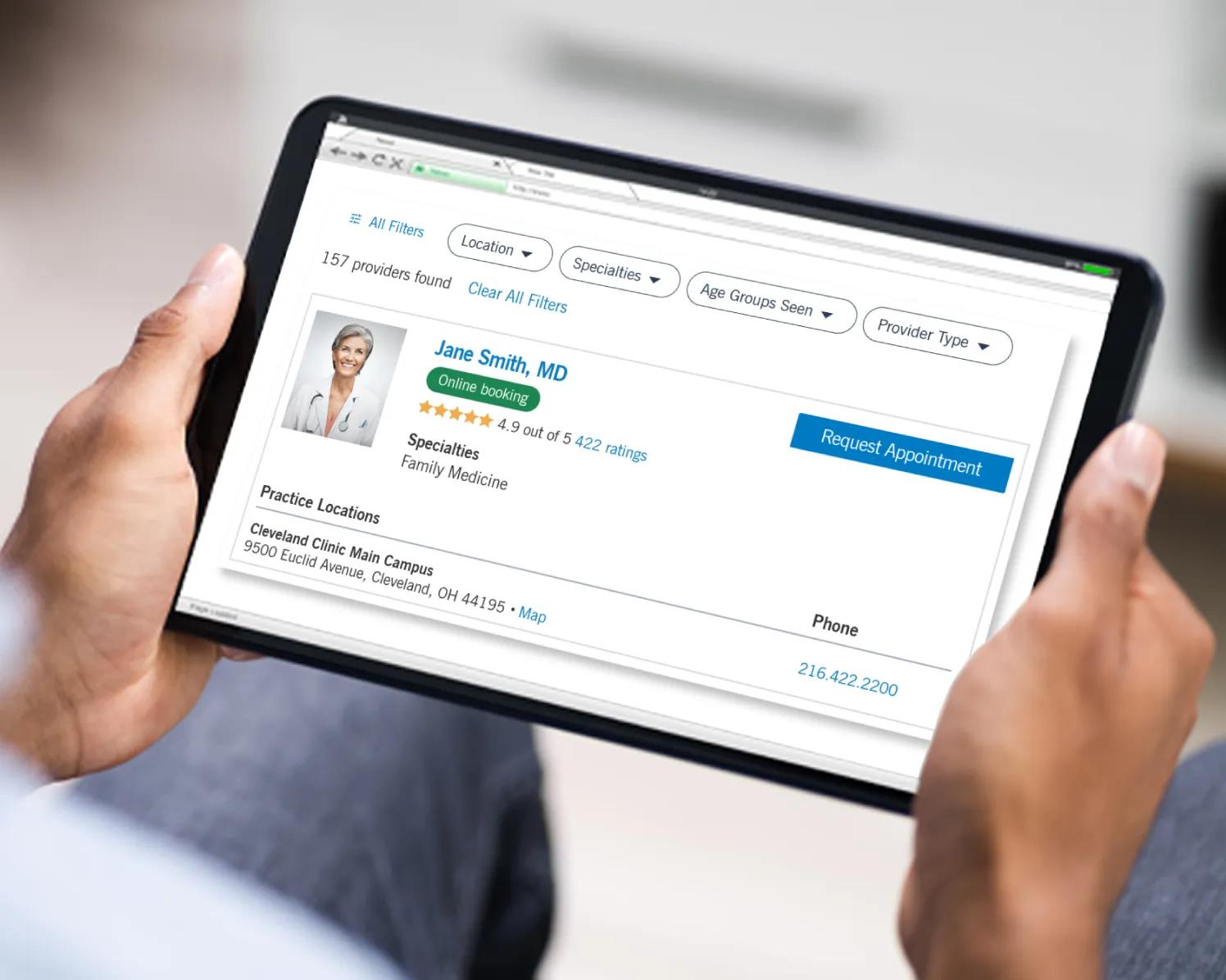 Person holding tablet looking at Cleveland Clinic provider profiles