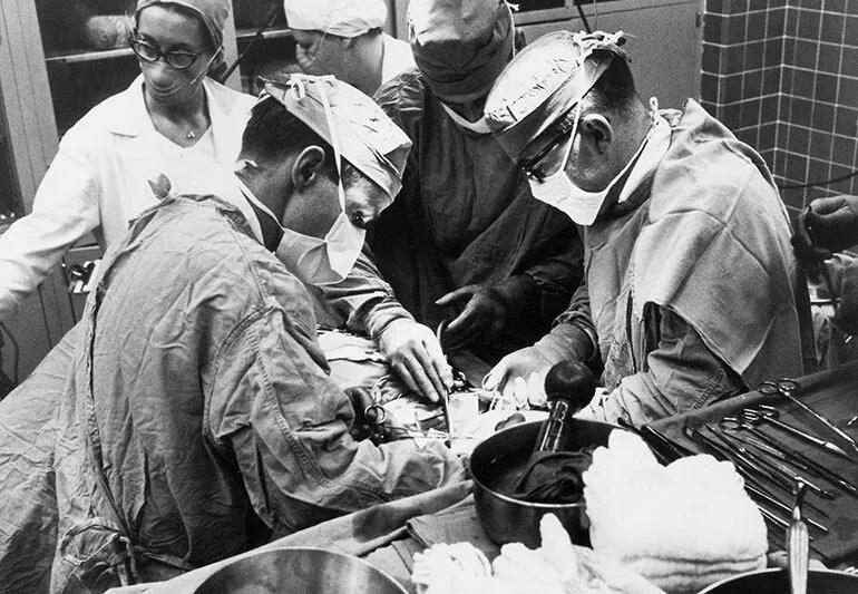 Ralph Straffon, MD, Bruce Stewart, MD, and Eugene Poutasse, MD during a kidney transplant